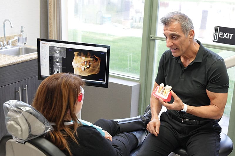 Lakeview Dr. Arooni explaining implants to patient