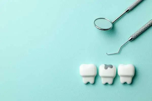 Dental tools and tooth models illustrating loose filling repair options Dental tools and tooth models illustrating loose filling repair options