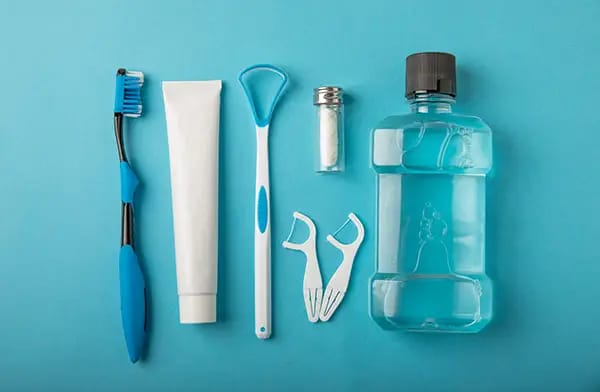 Oral hygiene supplies including toothbrush, toothpaste, floss, and mouthwash properly stored Oral hygiene supplies including toothbrush, toothpaste, floss, and mouthwash properly stored