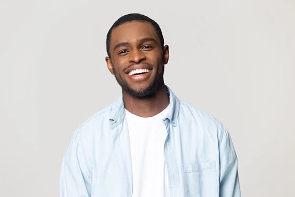 Man with confident bright smile after cosmetic dental treatment