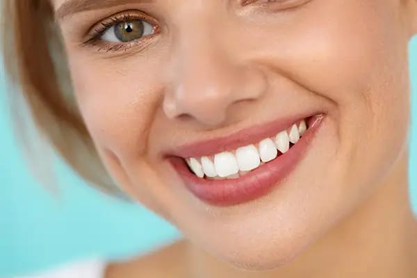 Woman with white smile highlighting teeth staining prevention from wine Woman with white smile highlighting teeth staining prevention from wine