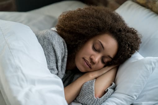 Woman sleeping peacefully with mouth closed for better oral health