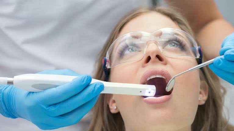 Woman having dental exam Woman having dental exam