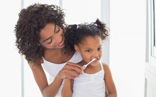 Mommy and daughter brushing teeth