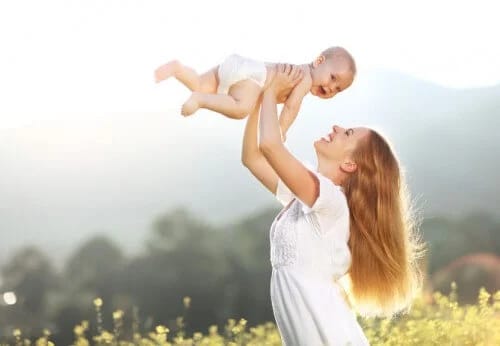 Mommy holding baby up in air Mommy holding baby up in air