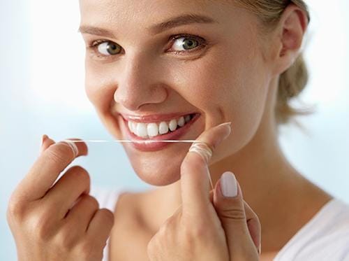 Woman Flossing