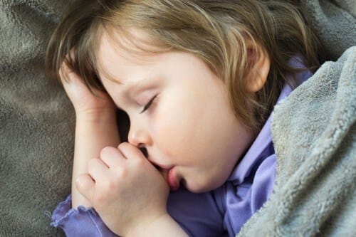 Child sucking thumb while sleeping