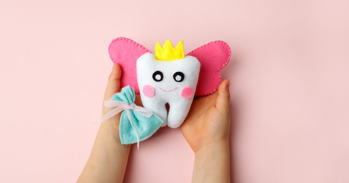 The child's hands are holding the Tooth Fairy. The child's hands are holding the Tooth Fairy.