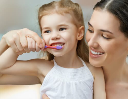 Mom teaching daughter how to brush teeath Mom teaching daughter how to brush teeath