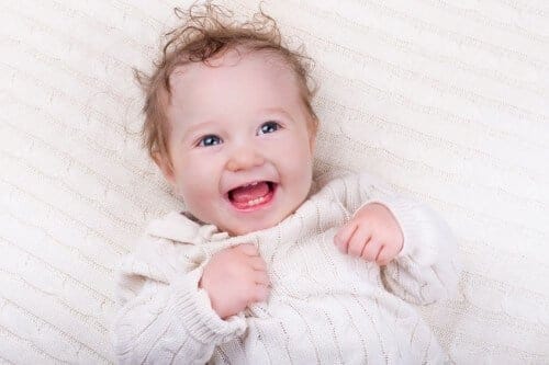 Smiling baby with new teeth