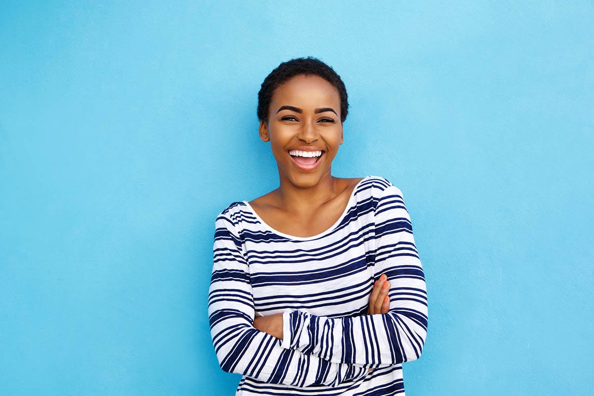 Happy female patient smiling after teeth cleaning from Dental One Associates