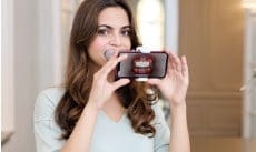 Woman monitoring orthodontic treatment with DentalMonitoring