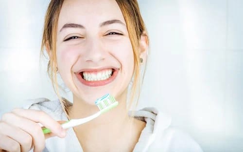 woman smiling with toothbrush