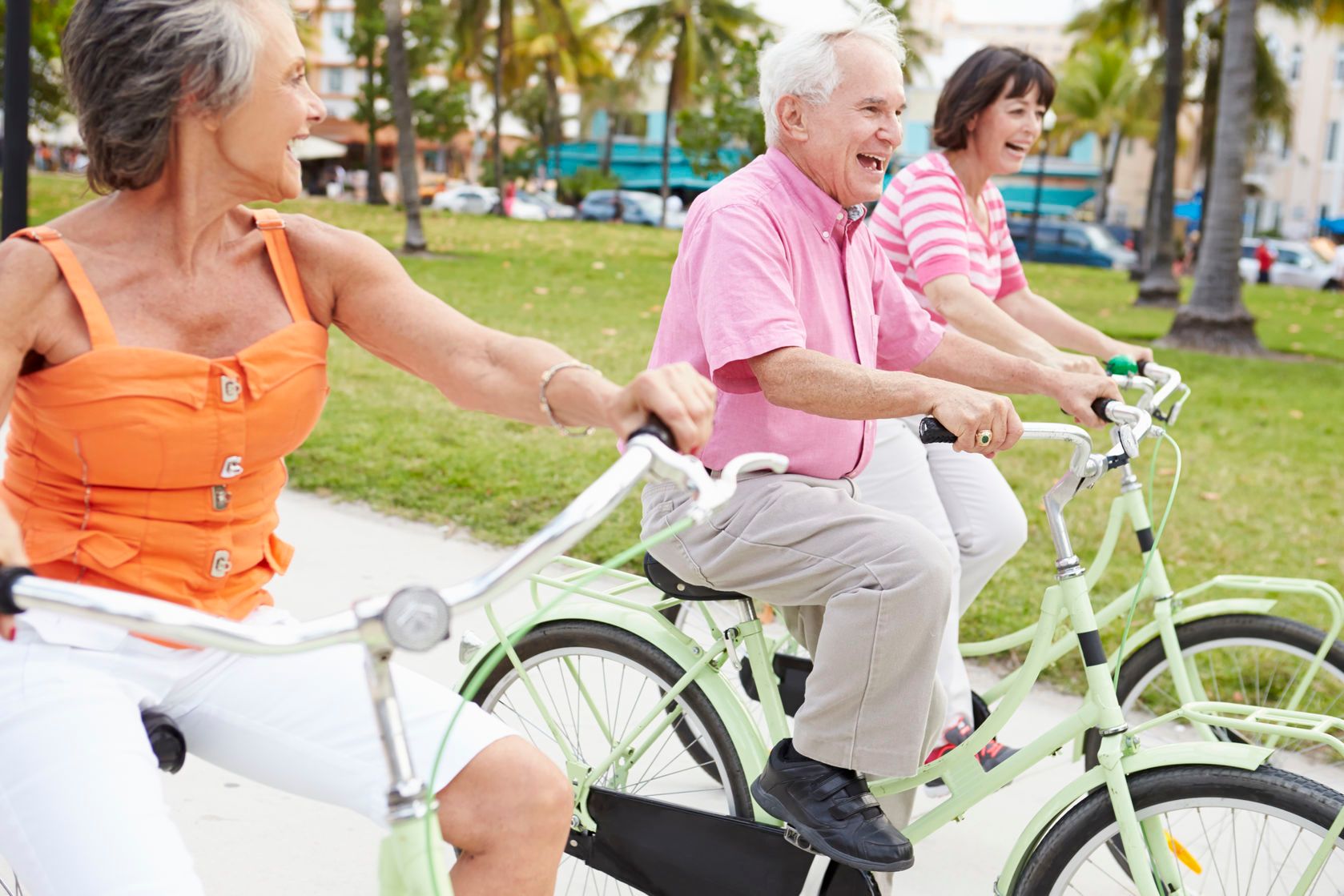 group of senior friends having fun on bicycle ride