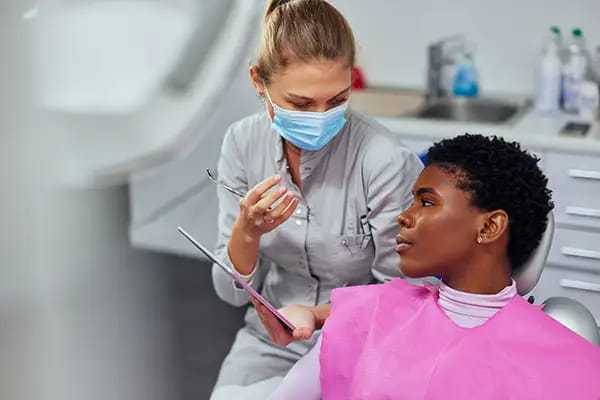 Friendly dentist consulting with patient to ease dental visit anxiety