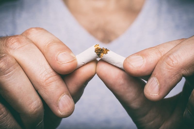 man breaking a cigarette man breaking a cigarette