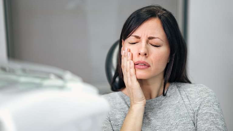 Lady holding her jaw due to migraines in Pikesville, MD Lady holding her jaw due to migraines in Pikesville, MD