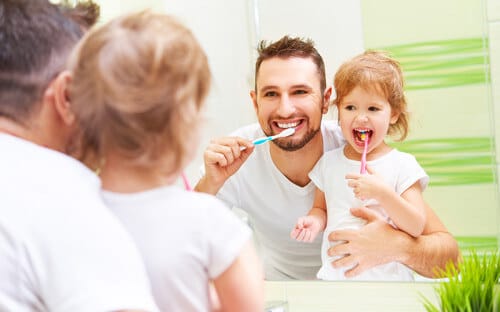 Daddy and daughter brushing teeth Daddy and daughter brushing teeth