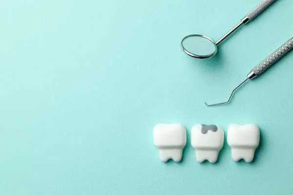 Dental tools and tooth models illustrating loose filling repair options Dental tools and tooth models illustrating loose filling repair options